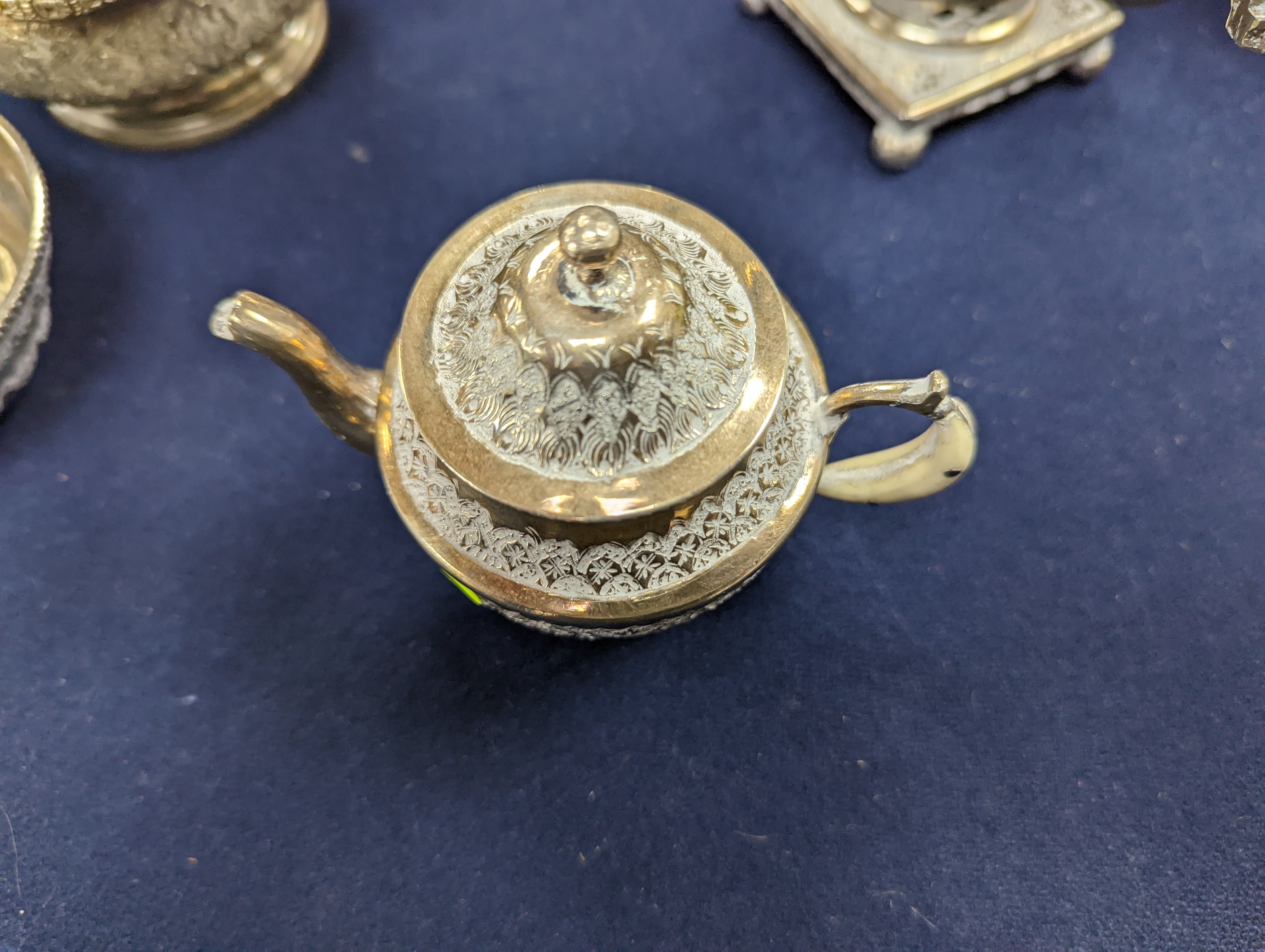 A set of six Persian embossed 84 standard white metal coffee cup holders and matching sugar bowl and cover by Vartan and four other Persian white metal items.